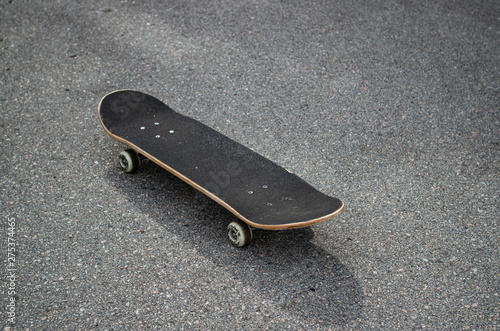 Skateboard isolated on the street photo