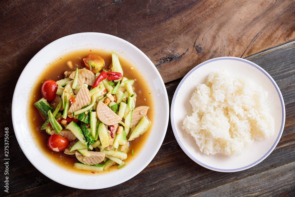 Spicy cucumber salad with sliced pork sausage and sticky rice, Thai food Spicy cucumber salad with sliced pork sausage and sticky rice, Thai food