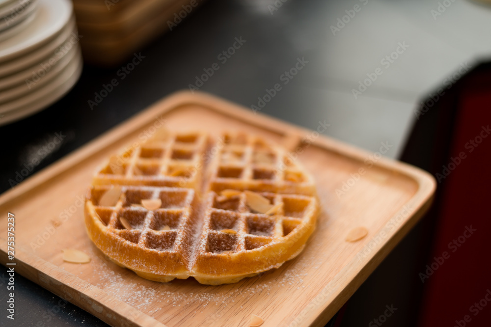 waffles with butter on wooden plate waffles with butter on wooden plate