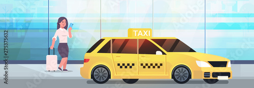 businesswoman using mobile app ordering taxi on street business woman in formal wear with luggage near yellow cab city transportation service concept full length flat horizontal