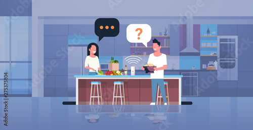 couple using smart speaker man woman preparing food asking recipe voice recognition concept modern kitchen interior flat horizontal full length