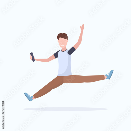 man taking selfie photo on smartphone camera casual male cartoon character jumping posing white background flat full length