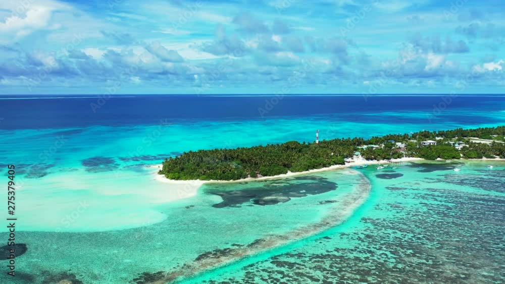 Side aerial clip of a small private island resort on the reef in the Maldives islands, a paradise for snorkeling and diving Side aerial clip of a small private island resort on the reef in the Maldives islands, a paradise for snorkeling and diving