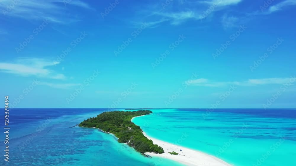 Drone descending in front of an elongated white sand peninsula extending from a deserted tropical island in the Caribbean Drone descending in front of an elongated white sand peninsula extending from a deserted tropical island in the Caribbean
