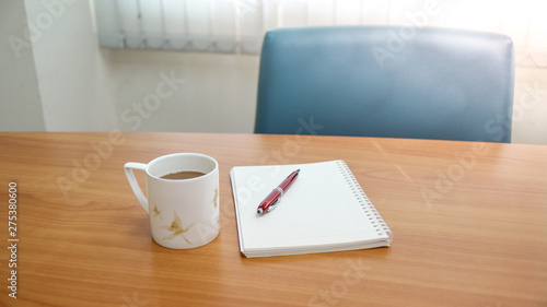 cup of coffee and notebook on a table