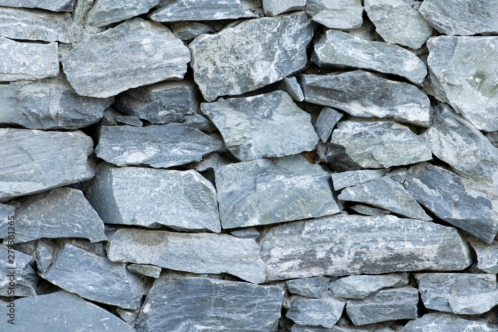 Fototapeta premium Stone wall background close up. Rock texture background.