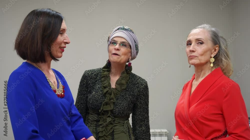 Elderly women gossip with each other, talking and discussing their problems. They are in elegant wear. Friendly conversation at the meeting. Elderly women gossip with each other, talking and discussing their problems. They are in elegant wear. Friendly conversation at the meeting.