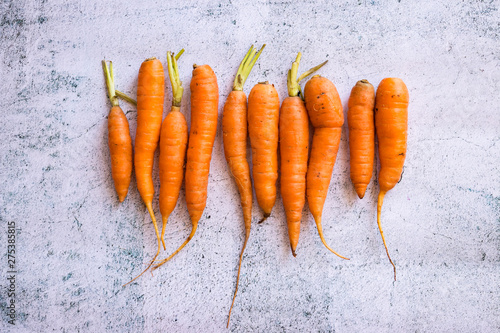 Fresh orange whole sweet carrots on white background.