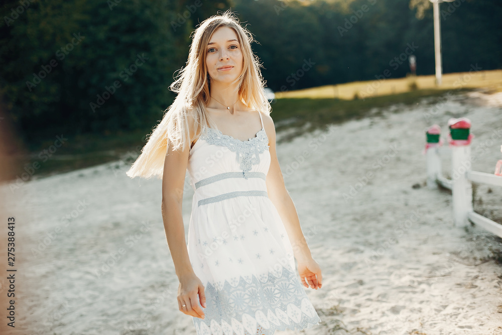 Beautiful girl in a white dress. Lady have fun in a summer park Beautiful girl in a white dress. Lady have fun in a summer park