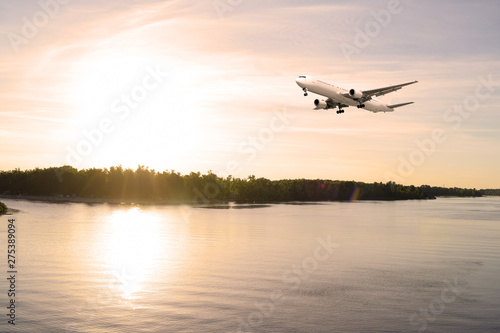 Airliner over the river. Sunset in the evening. © YAROSLOVEPHOTOVIDEO