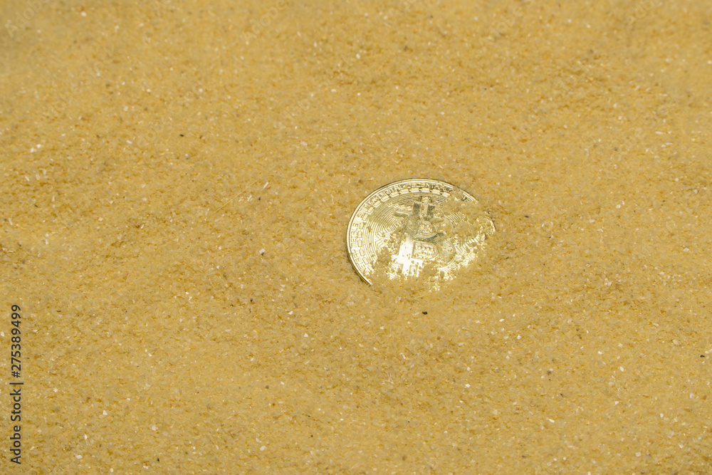 one bitcoin crypto coin on brilliant golden sand. finding and mining cryptocurrency one bitcoin crypto coin on brilliant golden sand. finding and mining cryptocurrency