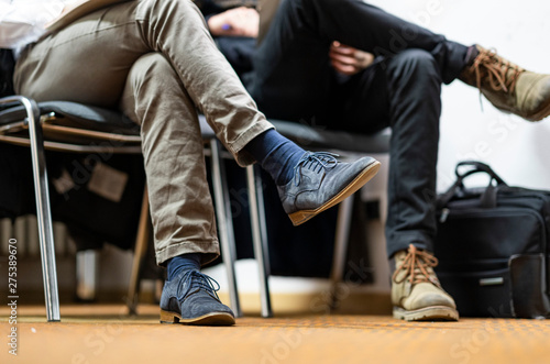 closeup of two people waing in a waiting area