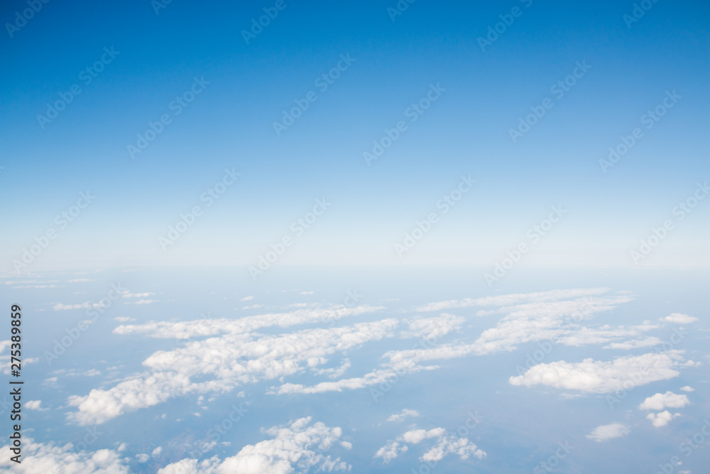 Blue sky with clouds background. View from airplane