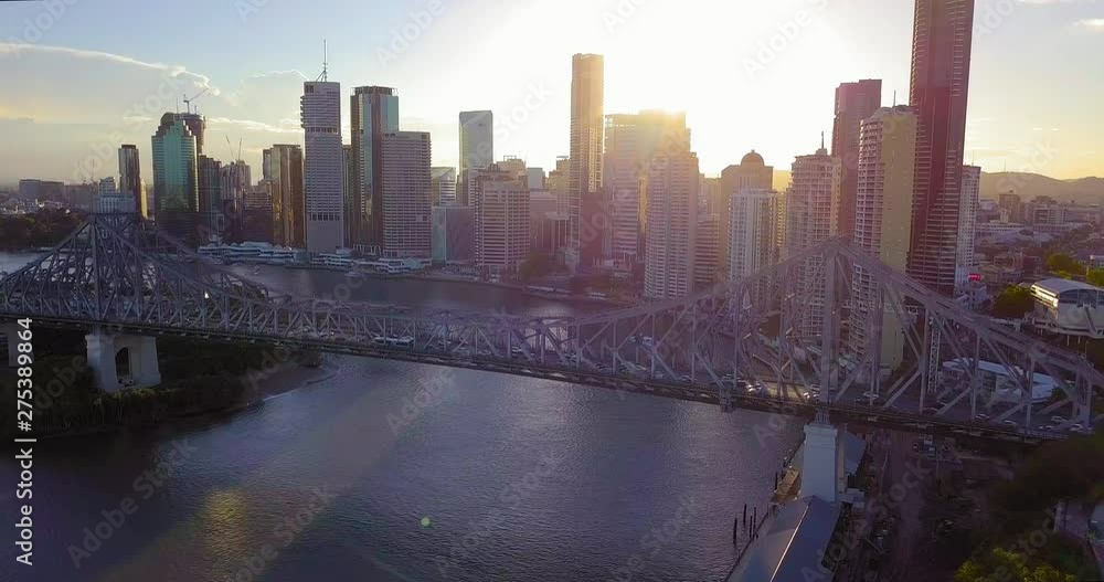 Forward moving aerial view of a city center with tall buildings and bridge over the river at sunset. Brisbane, Australia. Forward moving aerial view of a city center with tall buildings and bridge over the river at sunset. Brisbane, Australia.