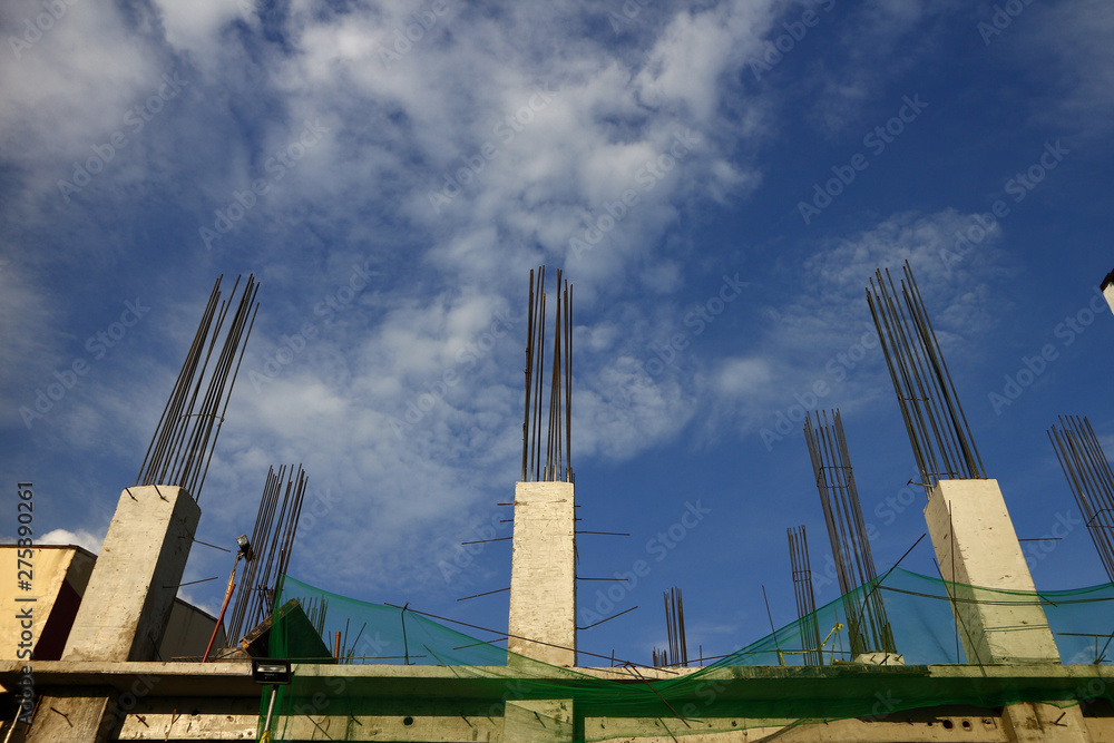 Concrete and steel pillars of an unfinished building at a construction site Concrete and steel pillars of an unfinished building at a construction site