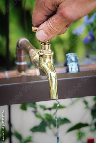 Man s hand on vintage brass tap