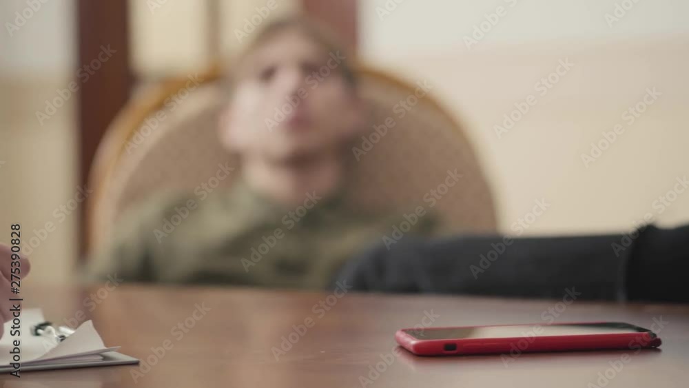 Unrecognized psychologist having session with her patient. The guy shares his problems and fears