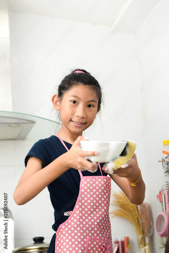Asian girl washing dishes in kitchen at home, housework lifestyle concept. Asian girl washing dishes in kitchen at home, housework lifestyle concept.