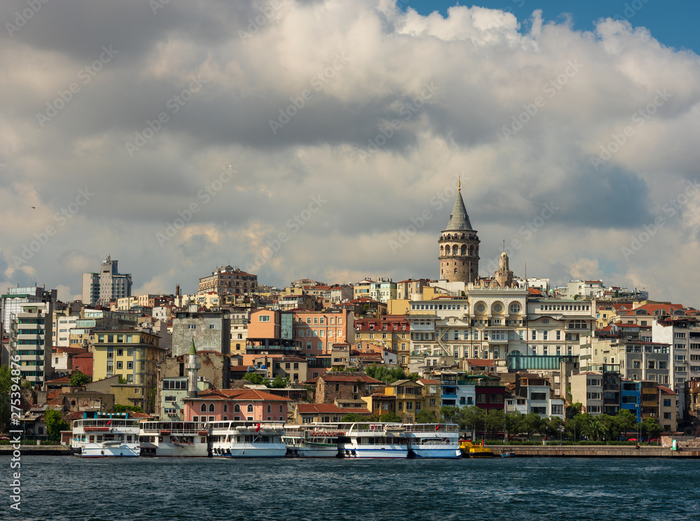 Beyoglu district old houses with Galata tower on top, view from the Golden Horn. June 26, 2019, Istanbul, Turkey 