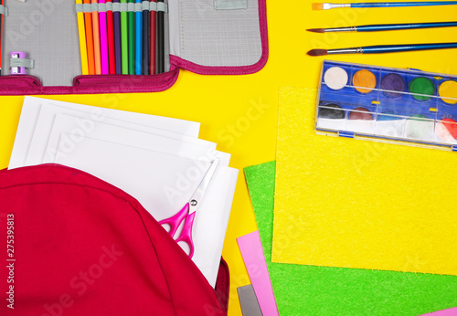 Different colorful School supplies on yellow background. Back to school sale, sopping concept