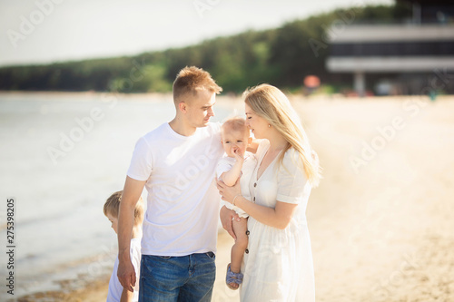 Happy family with two children enjoying summer holiday at beach in Estonia, Tallinn