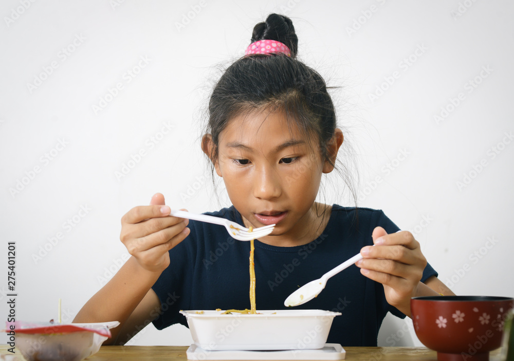 Asian girl eating spaghetti food box from convenient store, modern lifestyle concept. Asian girl eating spaghetti food box from convenient store, modern lifestyle concept.