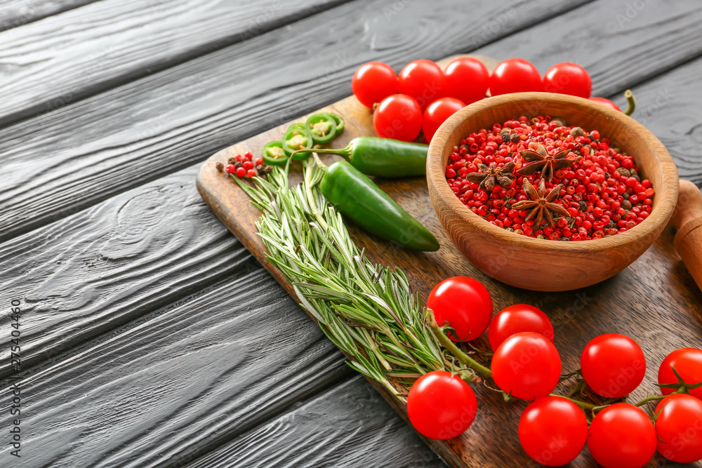Board with spices, fresh vegetables and rosemary on dark wooden table Board with spices, fresh vegetables and rosemary on dark wooden table