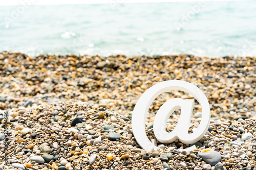 Email sign on the sea pebbles on the background of the sea. Concept for email, communication or contact us