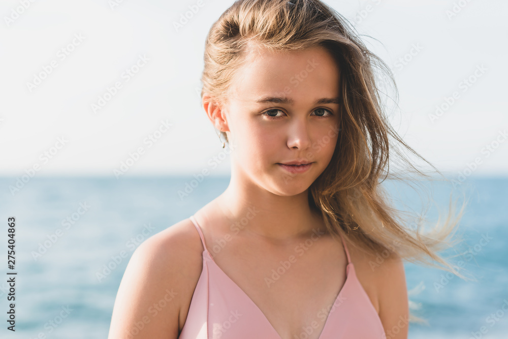 young slim beautiful woman in pink bikini on tropical beach. Portrait of happy young woman smiling at sea. Girl in swimwear enjoying and walking on beach. young slim beautiful woman in pink bikini on tropical beach. Portrait of happy young woman smiling at sea. Girl in swimwear enjoying and walking on beach.