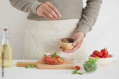 Fresh delicious salad with tomatoes. Doing fresh green salad