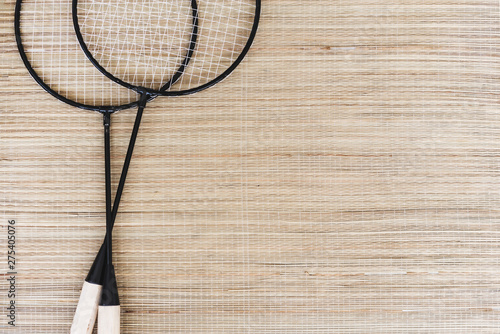 badminton racket on natural straw background. copy space