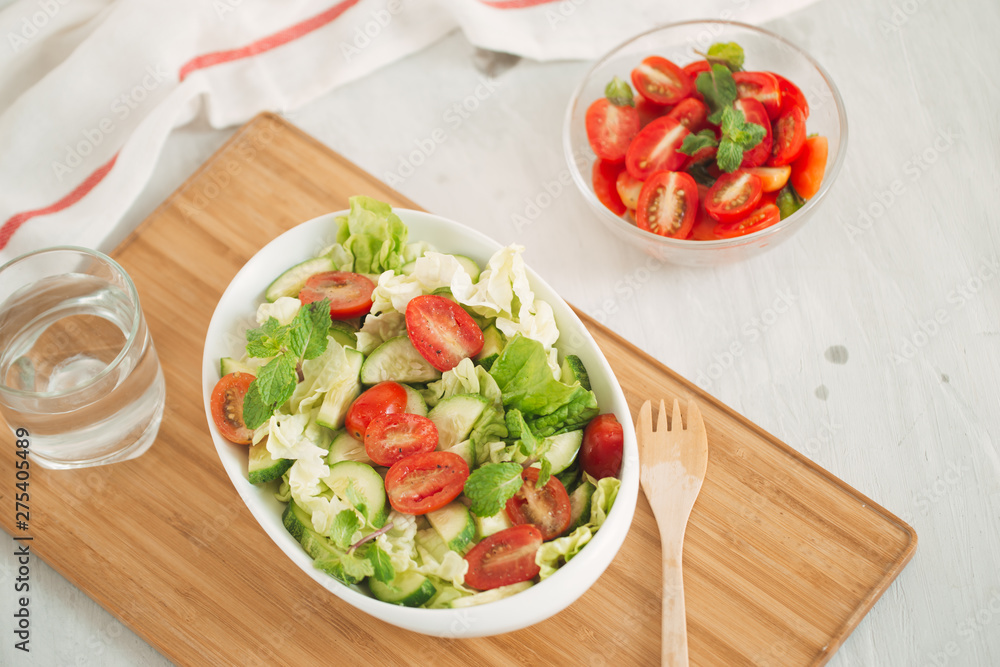 Healthy lifestyle, diet concept. Doing fresh green salad Healthy lifestyle, diet concept. Doing fresh green salad