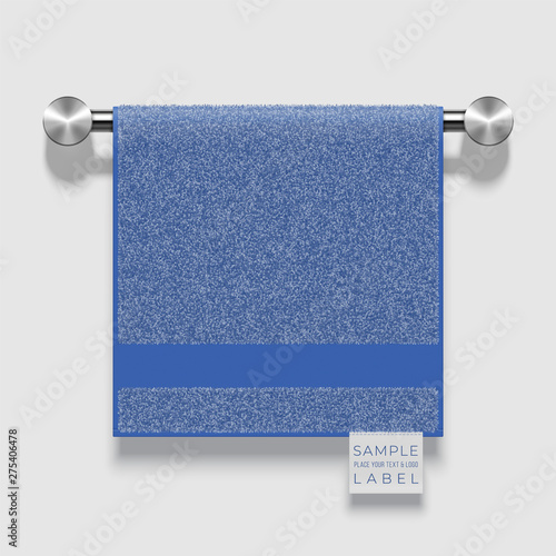 Vector realistic terry towel with a label template hanging on a metallic holder
