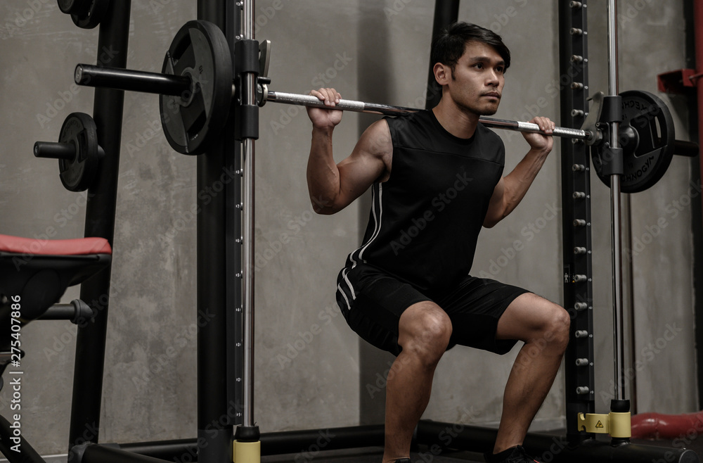 Asian men exercise at the gym Asian men exercise at the gym