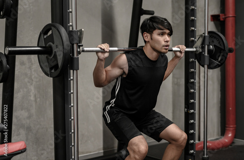 Asian men exercise at the gym