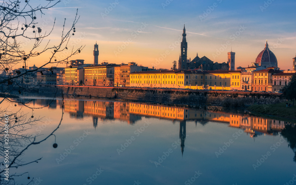 Florence ancient town skyline reflecting in the Arno river during the last moments of sunset, Tuscany, Italy