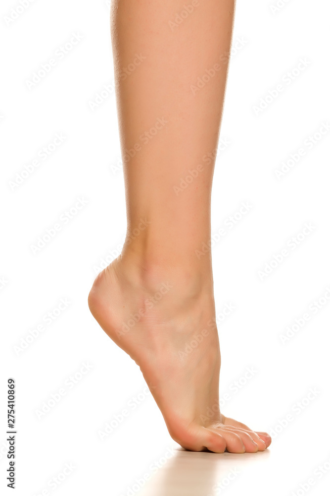 Side view of female bare foot on white background Side view of female bare foot on white background