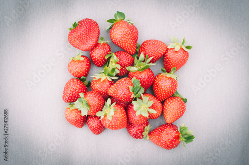Fresh strawberries on grey background.