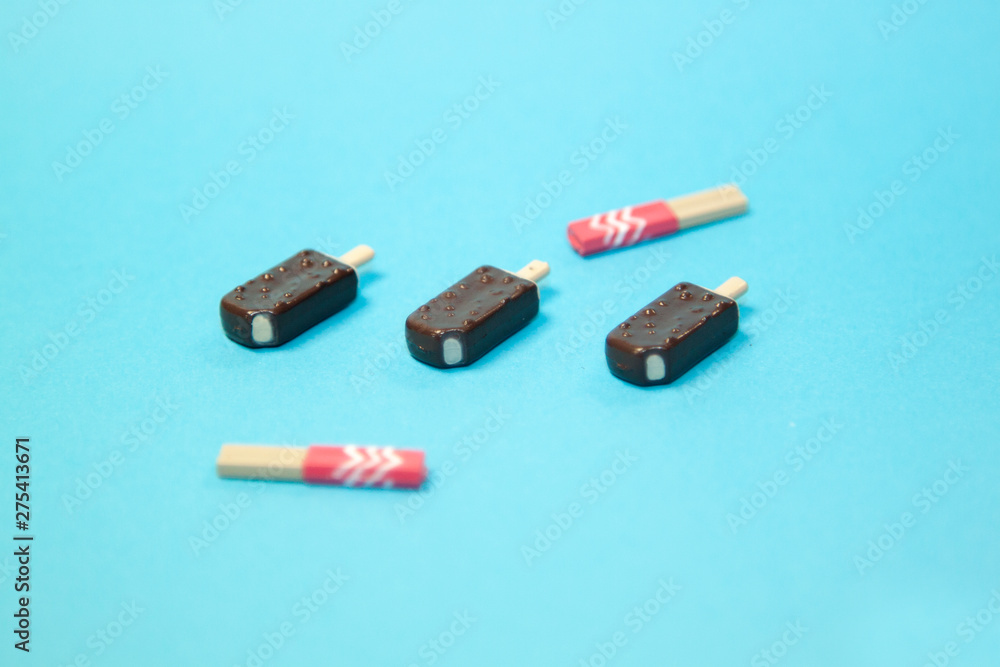 classic bitten popsicles choc-ice Lollipop ice cream in chocolate glaze on blue pastel background classic bitten popsicles choc-ice Lollipop ice cream in chocolate glaze on blue pastel background