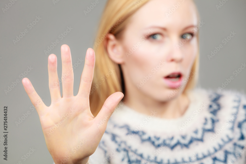 Woman making stop gesture with open hand Woman making stop gesture with open hand