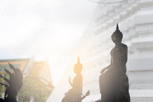 Thai Buddha statue silhouette with flare background
