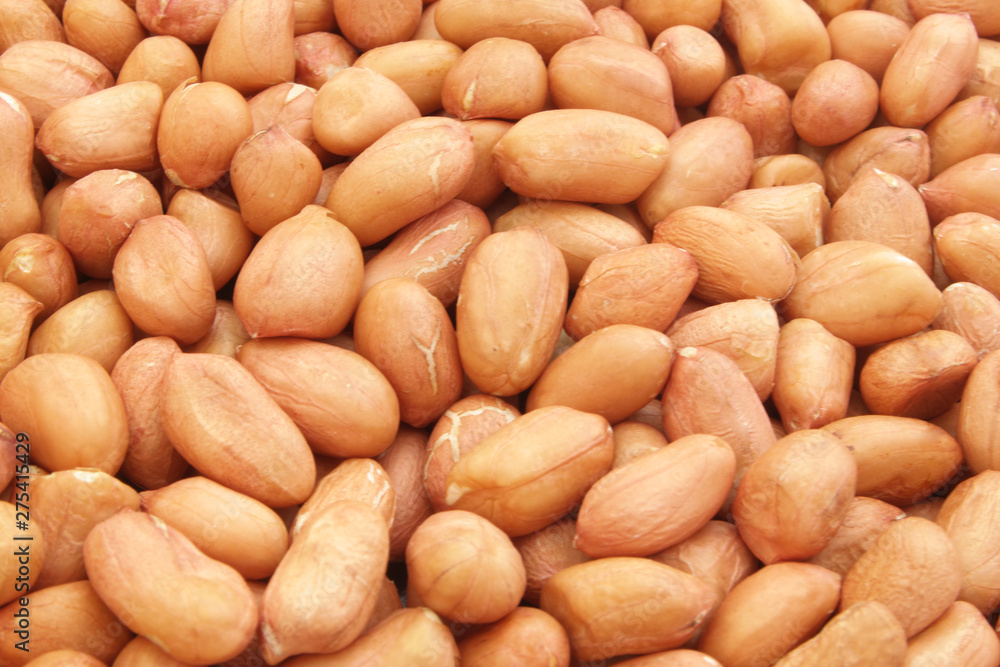 Peanuts background, many raw peanuts close up Peanuts background, many raw peanuts close up