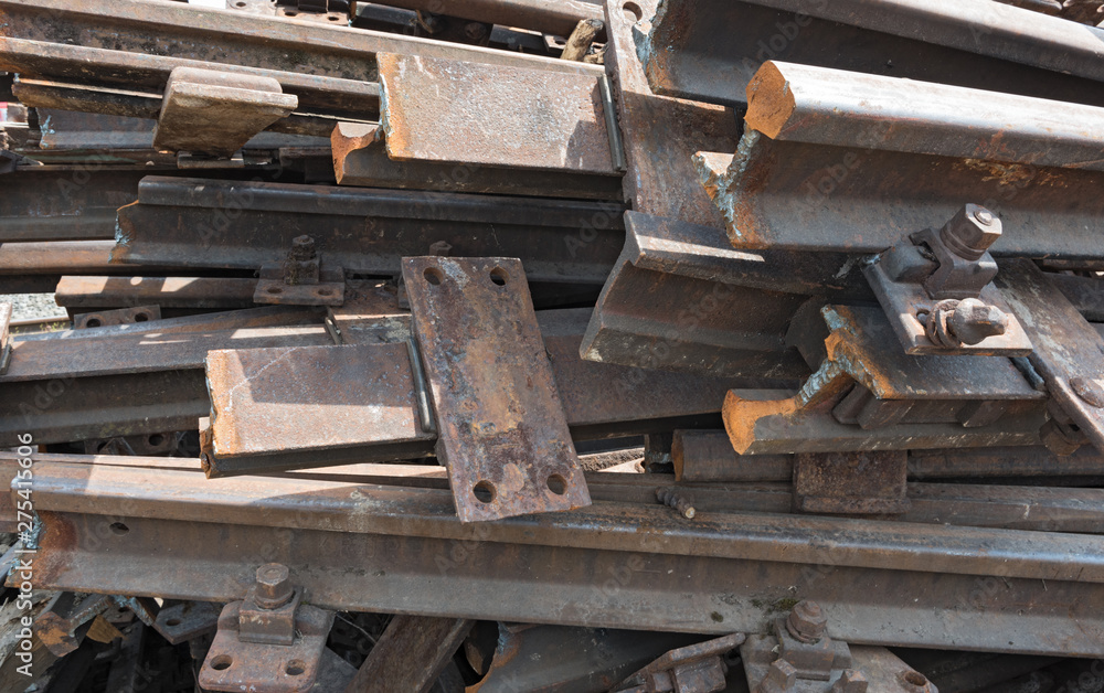 old rusty railroad tracks for scrapping in a warehouse space