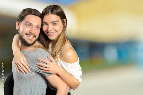 Happy couple embracing and looking at camera