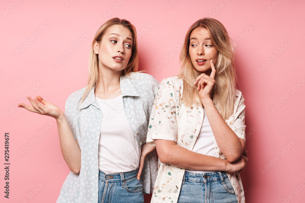 Two attractive blonde girls wearing summer outfit Two attractive blonde girls wearing summer outfit