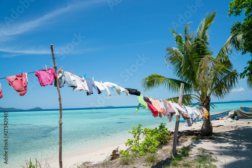 Clothes washed and hanging in tropical sun and wind to dry.