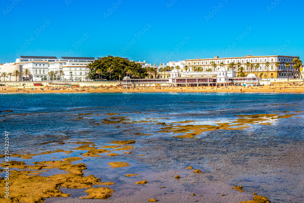 View of La Caleta Beach with El Balneario de la Palma or Spa of Our Lady of Palma and the Royal in Cadiz, Andalusia, Spain from the Castle of San Sebastian causeway