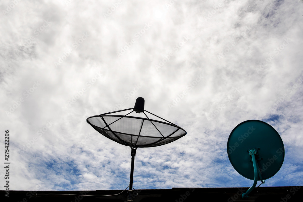 Satellite dish transmission data on background of cloudy sky Satellite dish transmission data on background of cloudy sky