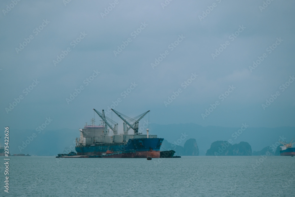 Business large cargo container ship logistics Quang Ninh city, Vietnam. Big cargo ship with containers, crane near the port, import export business logistic and transportation. Container ship mooring 