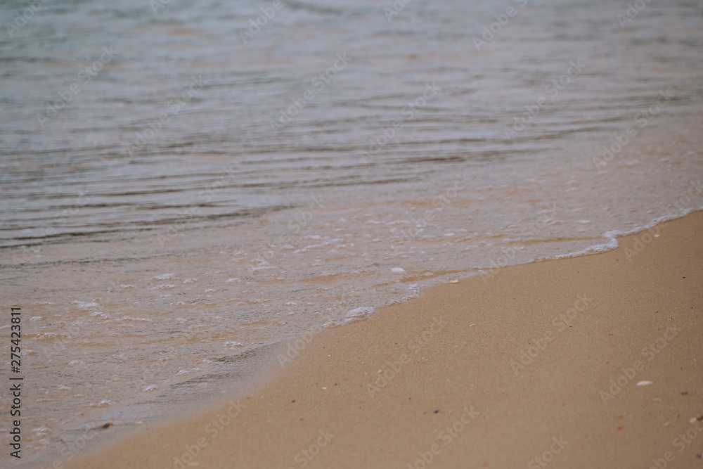 Beach top view with wave foam. Stock photo image of blue color of ocean water, sea surface. Soft blue ocean wave on sandy beach, turquoise waves, clear water surface texture. Nature background Beach top view with wave foam. Stock photo image of blue color of ocean water, sea surface. Soft blue ocean wave on sandy beach, turquoise waves, clear water surface texture. Nature background